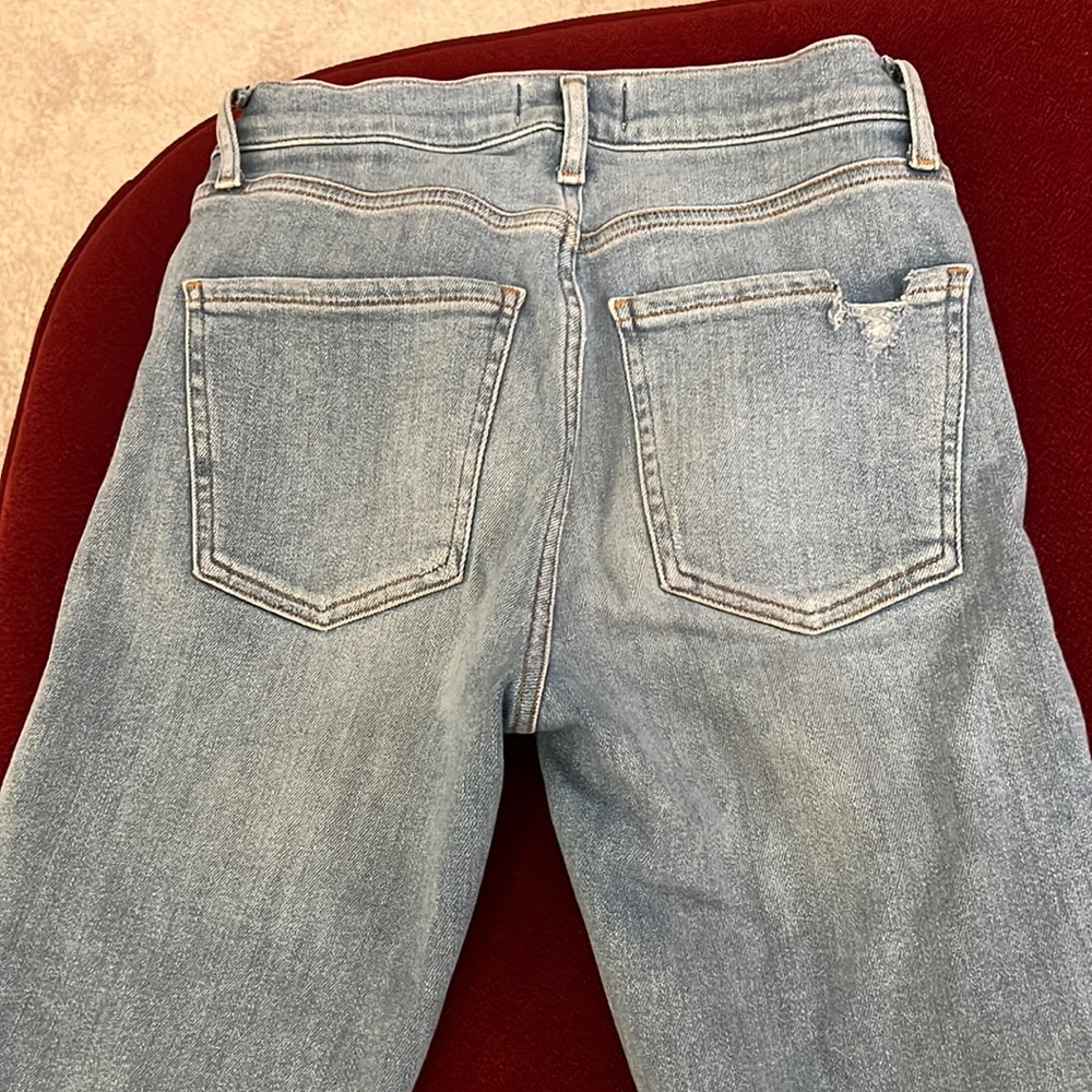 Agolde skinny ankle jeans in light wash. Raw hem, zipper button closure